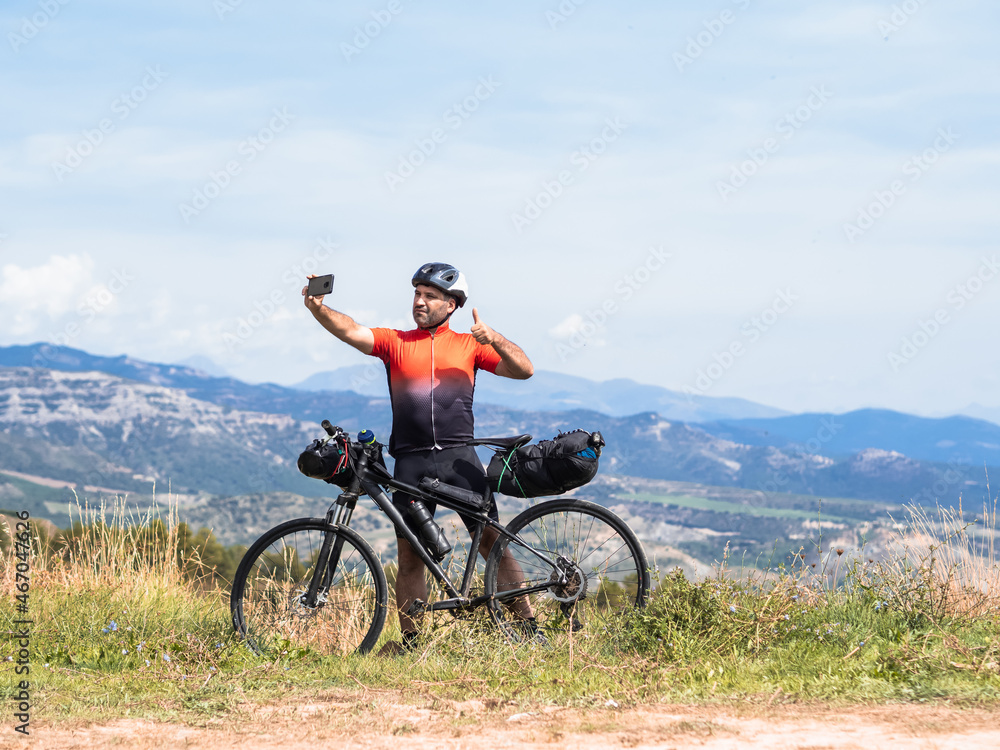 Adventurous cyclist man taking a selfie during his trip. Bikepacking, adventures