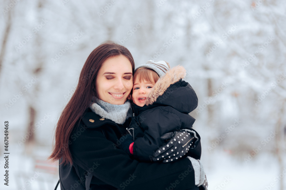 Obraz na plátně Happy Mother and Baby Girl Enjoying Winter Weather