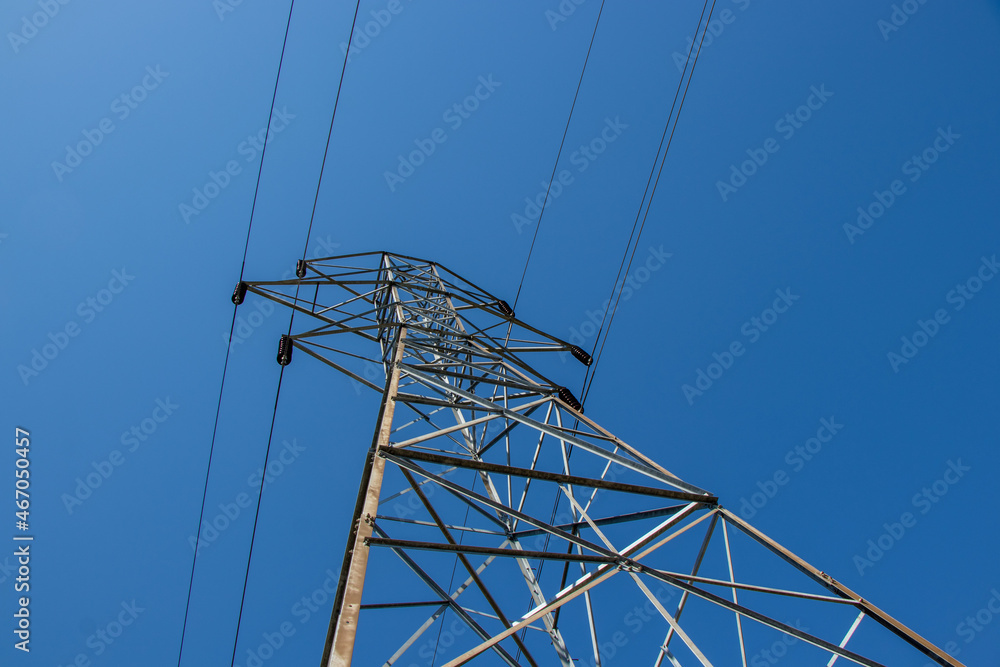 power line wires on a metal tower against a blue sky power line wires on a metal tower against a blue sky