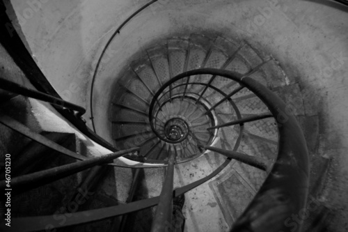 Downward spiral staircase in Black and White. 
Paris, France