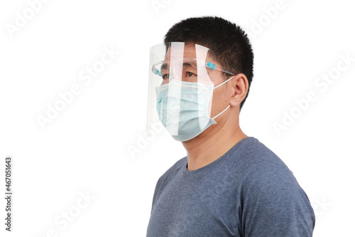 Potrait side view of a man wearing faceshield and facemask , now normal coronavirus protection on daily work photo