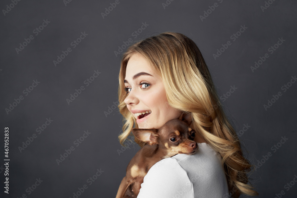 blonde with a small dog makeup posing dark background blonde with a small dog makeup posing dark background