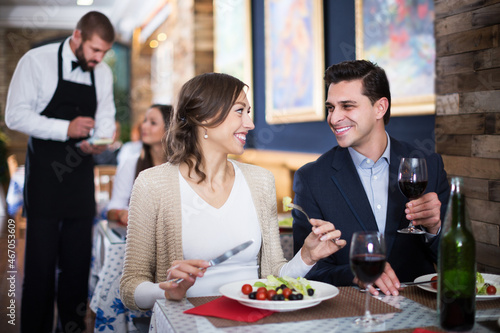 Portrait of smiling man and woman in the restaurant with alcohol drinks