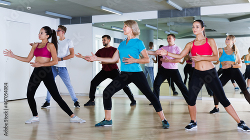 Different ages adults training swing steps at dance class