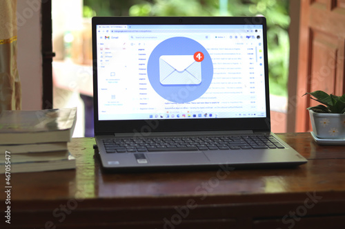 New email alert on laptop, communication connection message to global letters in the workplace.