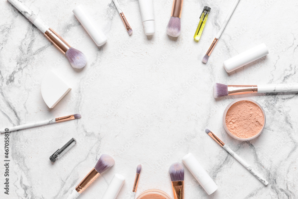 Frame made of professional makeup brushes with decorative cosmetics on white background Frame made of professional makeup brushes with decorative cosmetics on white background