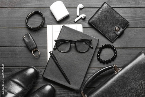 Set of stylish male accessories on dark wooden background
