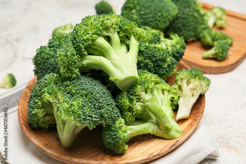 Plate with healthy broccoli cabbage on light background