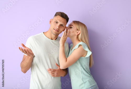 Gossiping young couple on c...