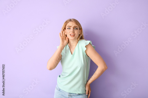 Young woman trying to hear ...