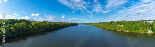 Aerial view of Mississippi river with green trees, blue sky and white clouds panorama Minnesota USA 