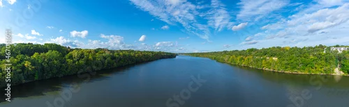 Obraz  z motywem Aerial view of Mississippi river with green trees,  blue sky and white clouds panorama Minnesota  USA 