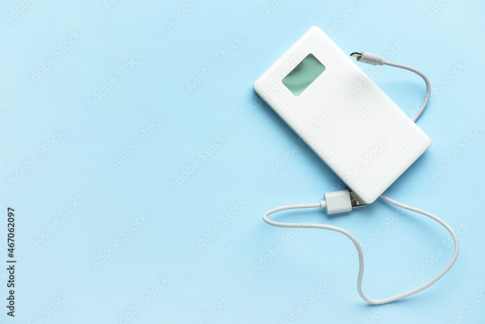 Modern power bank on blue background Modern power bank on blue background