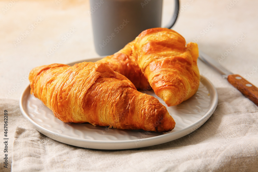 Plate with delicious croissants on white background Plate with delicious croissants on white background