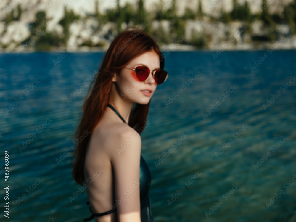 woman wearing green swimwear sunglasses posing leisure lifestyle