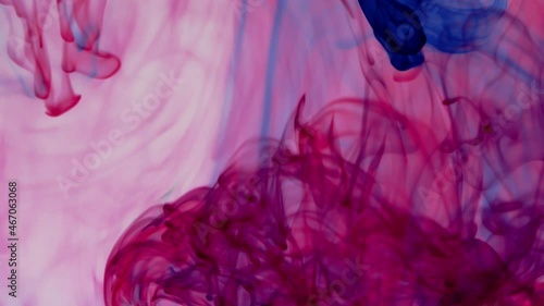 Multicolor pigment ink water explosion from above white background.