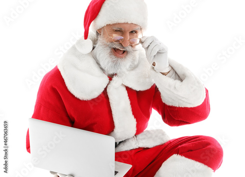 Happy Santa Claus with lapt...