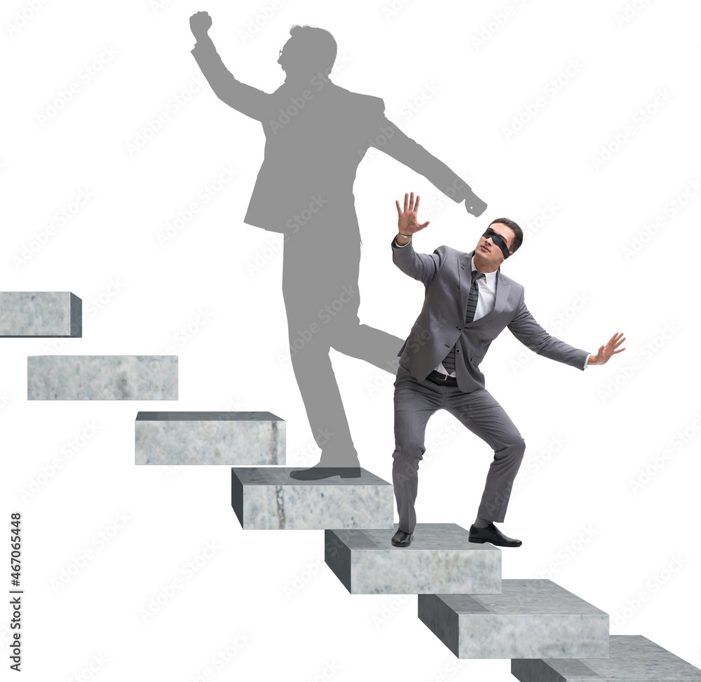 Businessman and his shadow in business concept Businessman and his shadow in business concept