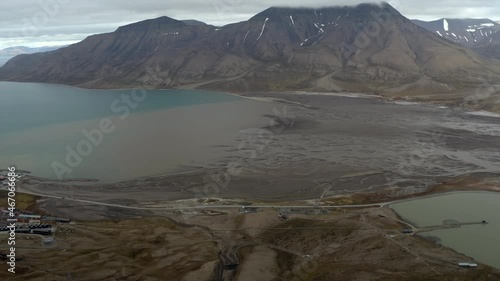 Orbiting shoot - turning left - revealing Longyearbyen - Capital of Svalbard. In port one cruise ship docked - overcast day. photo