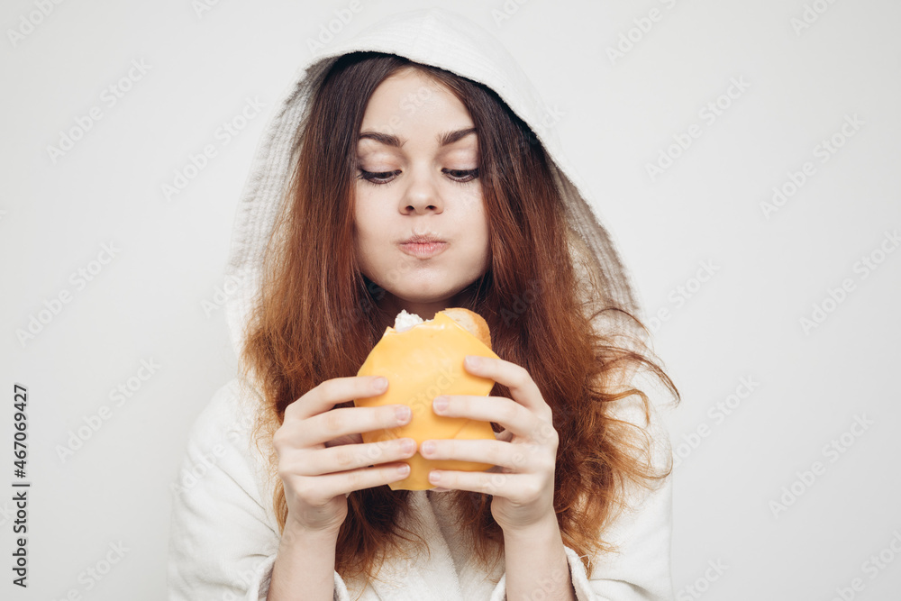 red-haired woman eating a sandwich snack lunch red-haired woman eating a sandwich snack lunch