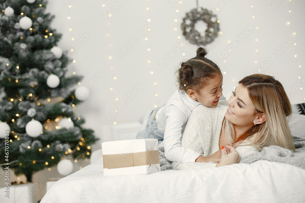 Caucasian mother with little african daughter at home Caucasian mother with little african daughter at home
