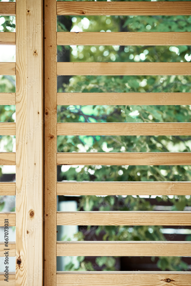 Decorative partition of wooden planks on house terrace