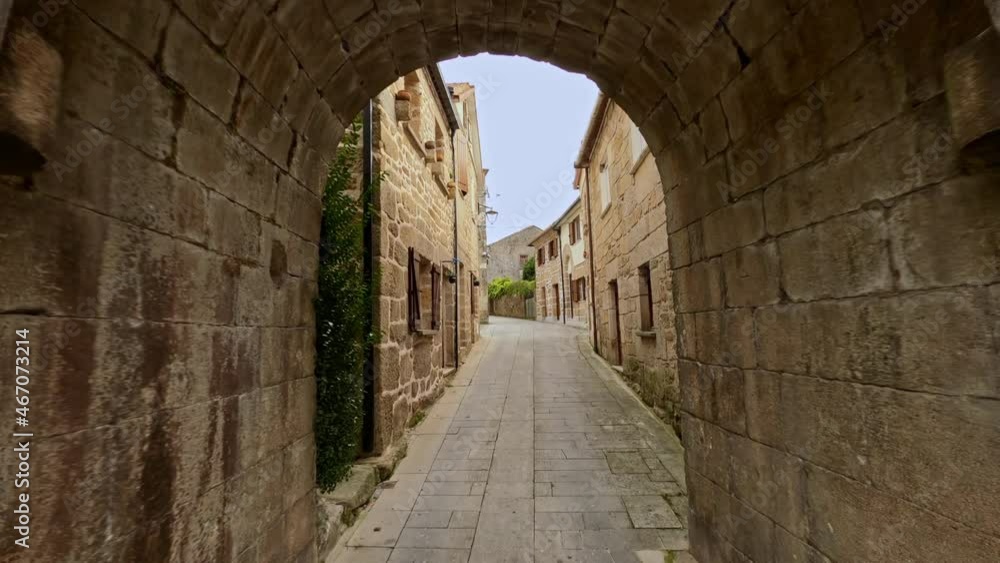 Travelling forward from entrance gate to the walled city of Melgaço, Portugal with low-rise housing on both sides. Travelling forward from entrance gate to the walled city of Melgaço, Portugal with low-rise housing on both sides.