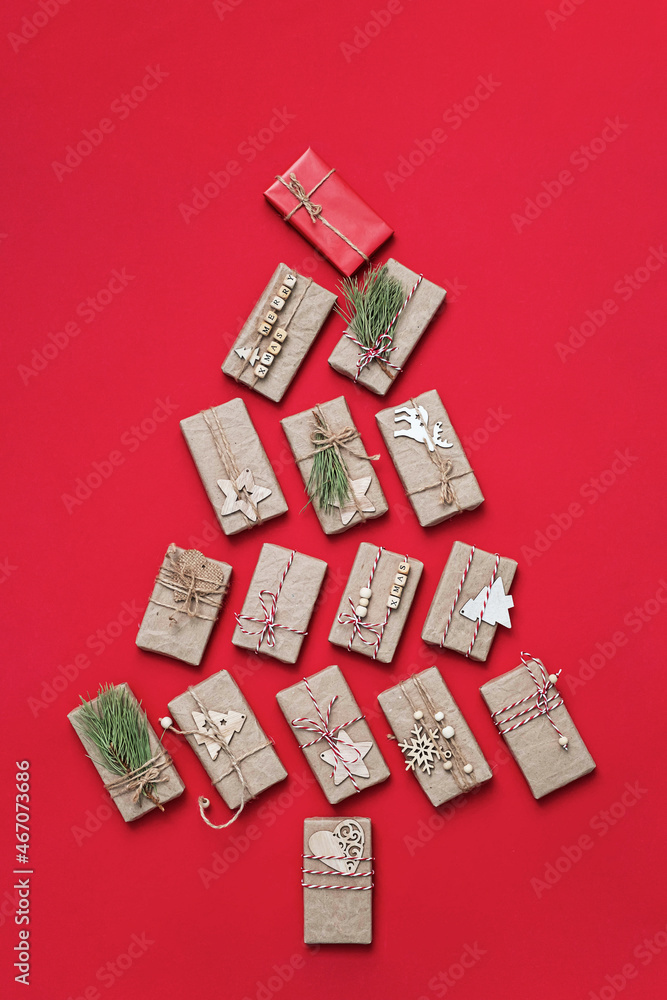 Christmas tree made from gifts. Gift boxes on red background, flat lay. Christmas holiday concept. Christmas tree made from gifts. Gift boxes on red background, flat lay. Christmas holiday concept.