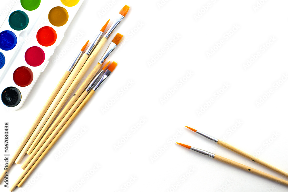 watercolor paints and brushes on a white background watercolor paints and brushes on a white background