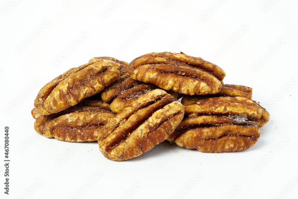 A pile of salty pecans isolated on white background. Close up of peeled pecans. 