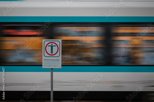 Warning signs for prohibited passage over railway tracks. Metal board for train crossing safety while the train is passing by.