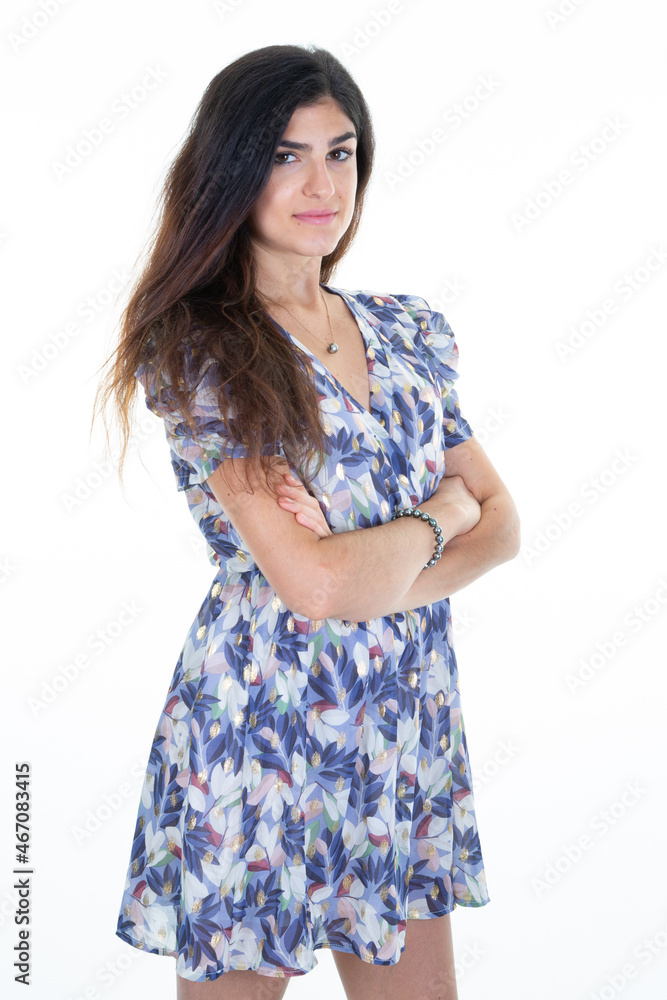 beautiful young woman with arms crossed in her summer dress looking posing in the camera beautiful young woman with arms crossed in her summer dress looking posing in the camera