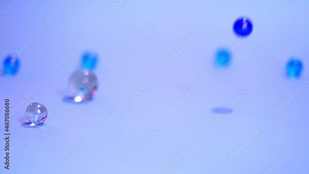 bouncing balls popping and rolling onto around, red ping-pong plastic fun ball movement. erratic movement of glass balls. selective focus, subject is out of focus