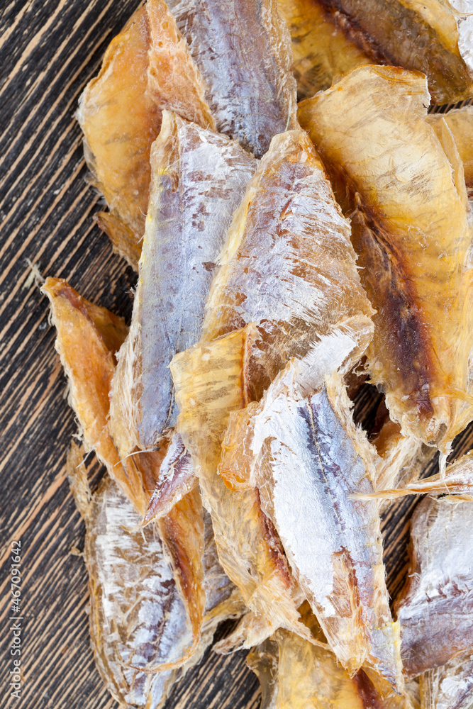 dried and butchered small fish on a wooden table