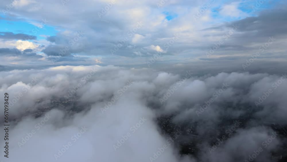 Aerial view from airplane window at high altitude of earth covered with puffy cumulus clouds forming before rainstorm Aerial view from airplane window at high altitude of earth covered with puffy cumulus clouds forming before rainstorm