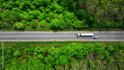 Aerial. Overtaking a truck by a passenger car. Top view from drone. photo