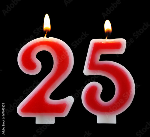 Red birthday candles isolated on black background, number 25