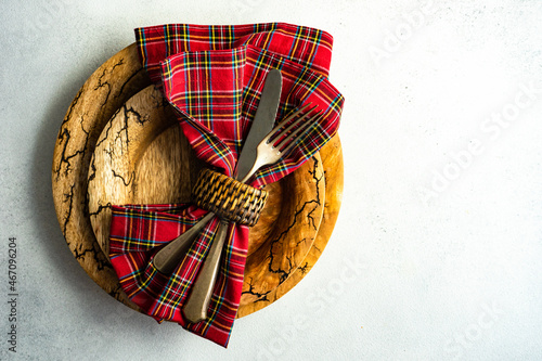 Overhead view of cutlery and a napkin in a napkin ring on a plate photo