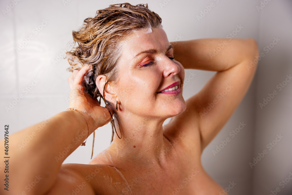 Woman washing hair with shampoo Woman washing hair with shampoo