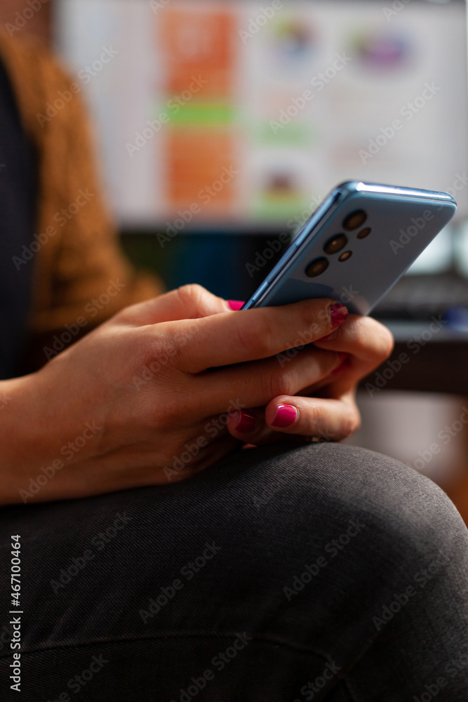 Closeup of businesswoman hand chatting with friend using modern smartphone while working in startup company office. Executive manager browsing on social media, searching business app Closeup of businesswoman hand chatting with friend using modern smartphone while working in startup company office. Executive manager browsing on social media, searching business app