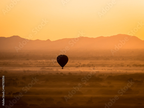 Myanmar - Bagan - A balloon flying over an orange landscape