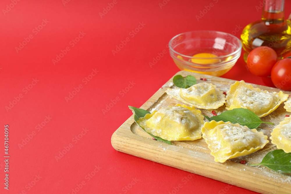 Concept of cooking ravioli on red background Concept of cooking ravioli on red background