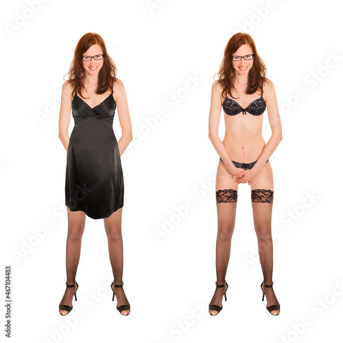 Attractive young woman undressing her black dress, full length portrait isolated in front of white studio background