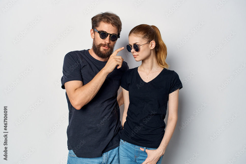 married couple in black t-shirt sunglasses posing light background married couple in black t-shirt sunglasses posing light background