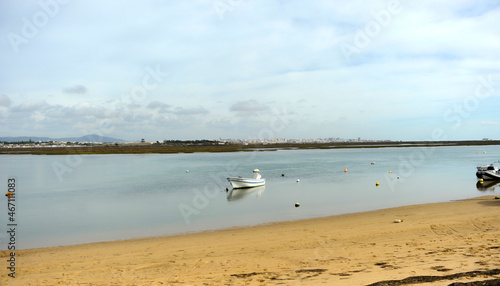 Boat in the Ria Formosa with the city of Faro in the background. Algarve Portugal Southern Europe. 