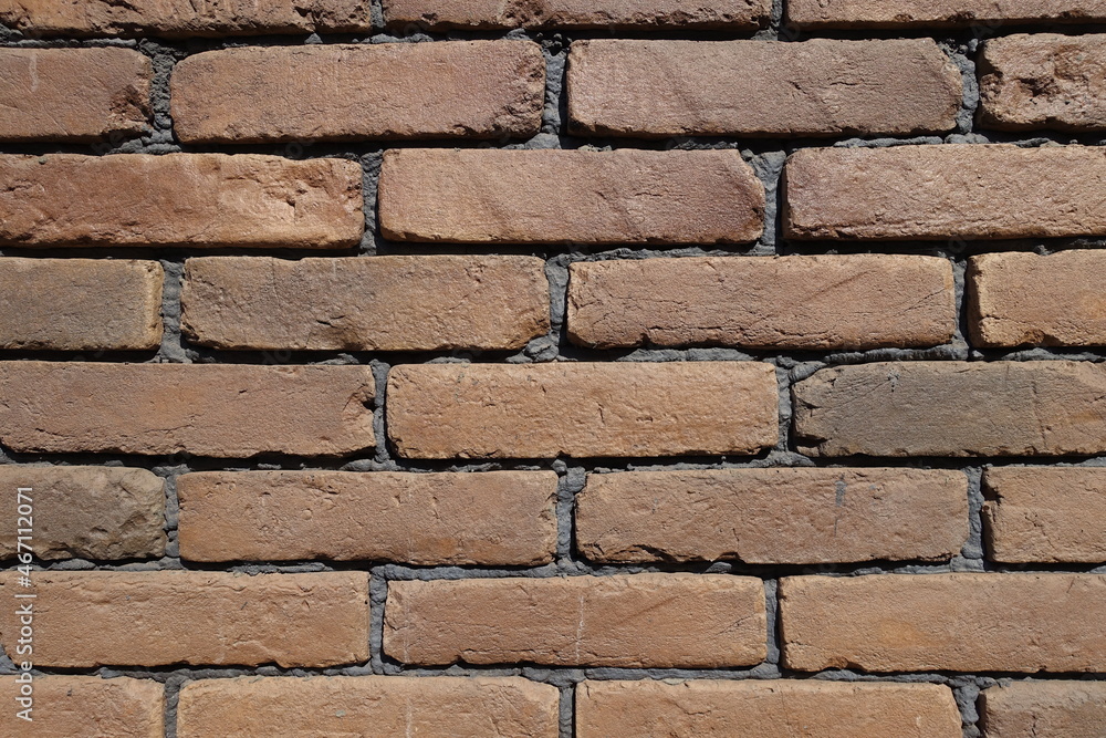 Front view of wall made of brown brick veneers Front view of wall made of brown brick veneers