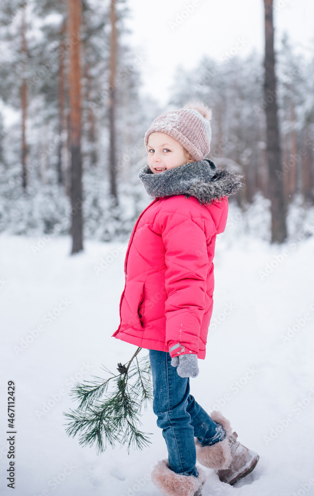 Little girl in a bright jacket plays in the winter forest Little girl in a bright jacket plays in the winter forest