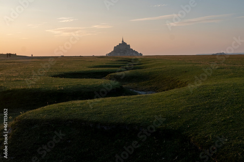 The famous landmark of Bretagne, Mont Saint Michel, is here seen lit in the early evening, just after sunset, France