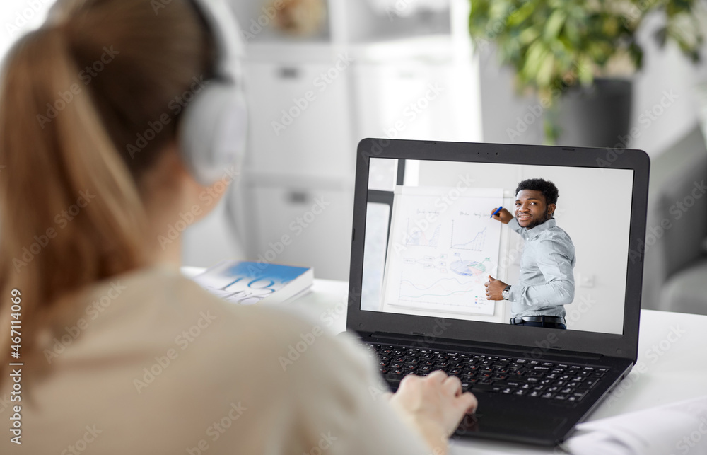 education, online school and distant learning concept - student woman in headphones having online class or meeting with teacher on laptop computer screen at home education, online school and distant learning concept - student woman in headphones having online class or meeting with teacher on laptop computer screen at home