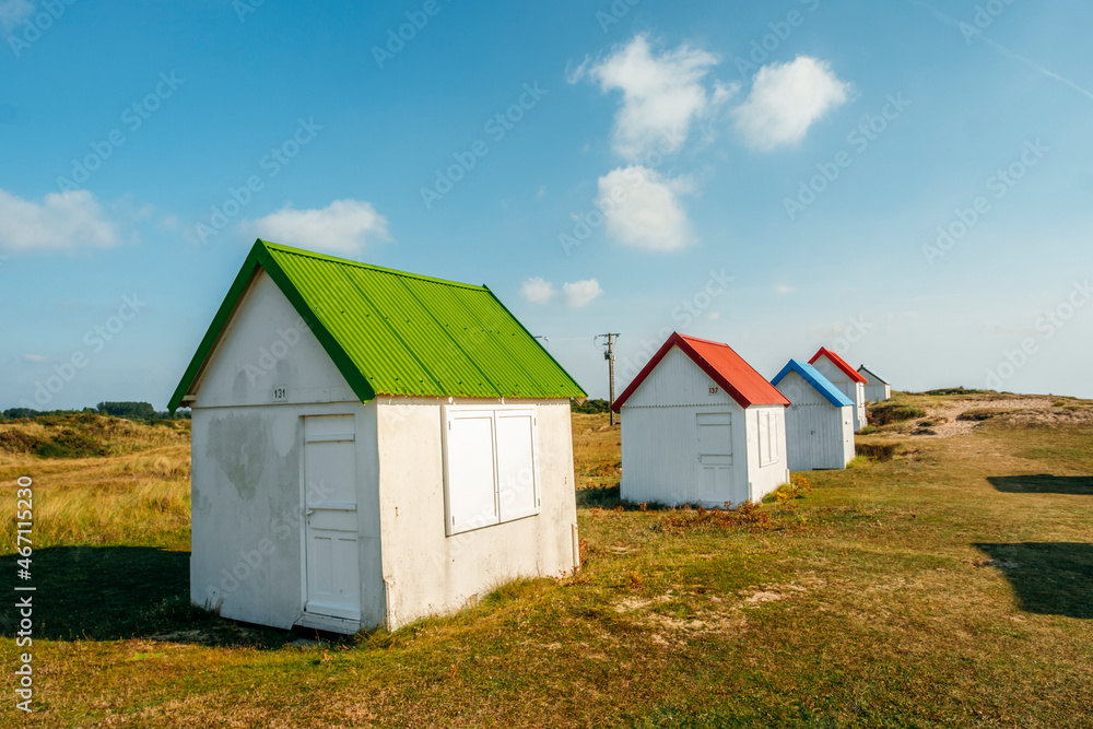 Row of colorful huts on the dune beach of Gouville-sur-Mer, Lower Normandy, France Row of colorful huts on the dune beach of Gouville-sur-Mer, Lower Normandy, France